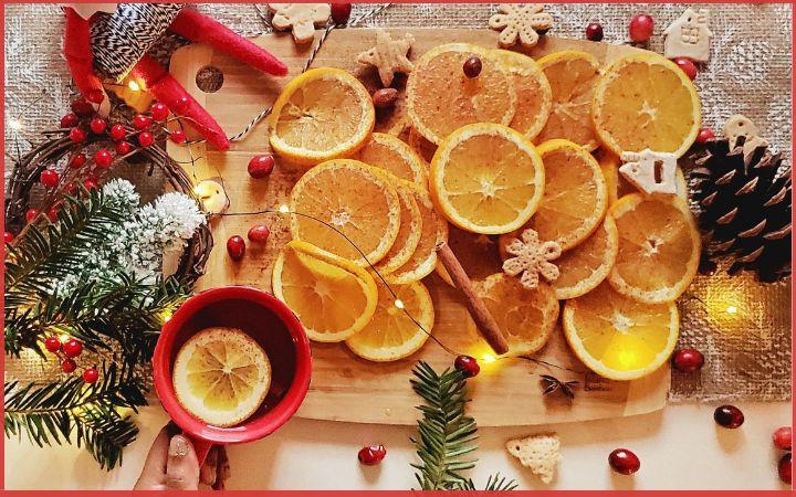 orange slices on wooden tray with cranberries scattered around