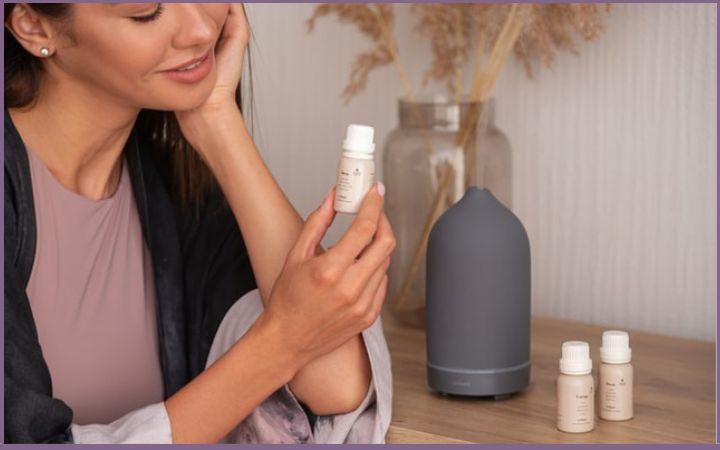 lady holding essential oil bottle in her hand