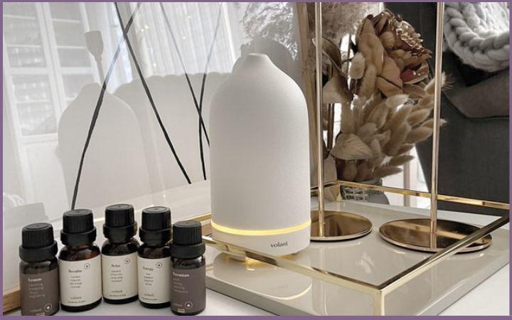 5 essential oil bottles and white diffuser