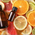 2 essential oil bottles on top of citrus slices