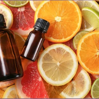 2 essential oil bottles on top of citrus slices