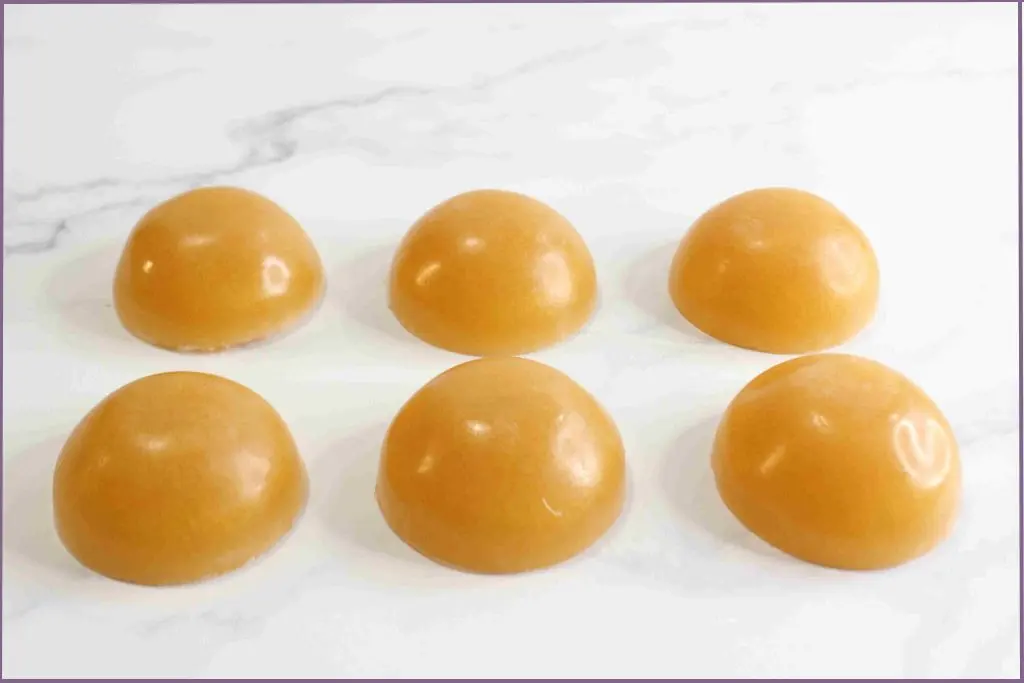 6 small golden soaps on flat surface