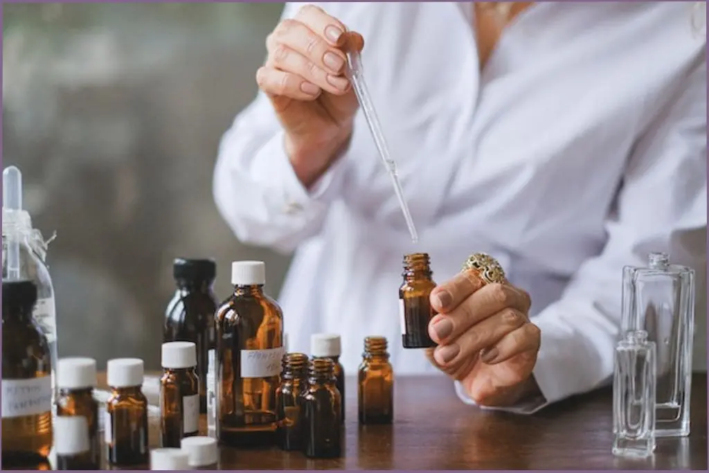 lady using a dropper to mix essential oils