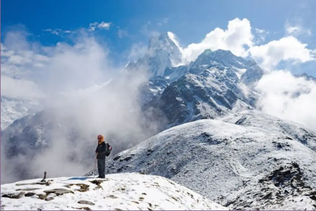 person standing on snowy mountain top