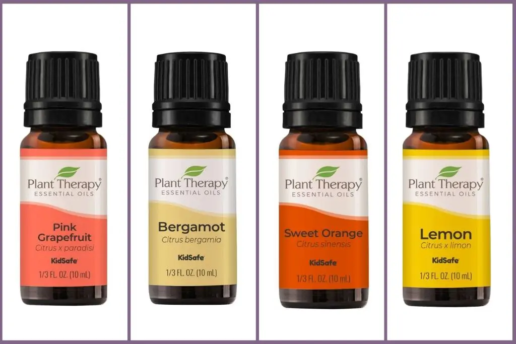 4 essential oil bottles from the citrus aroma family - grapefruit, begamot, sweet orange, and lemon