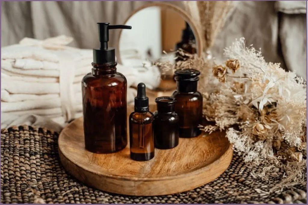 glass bottles on a round wooden tray