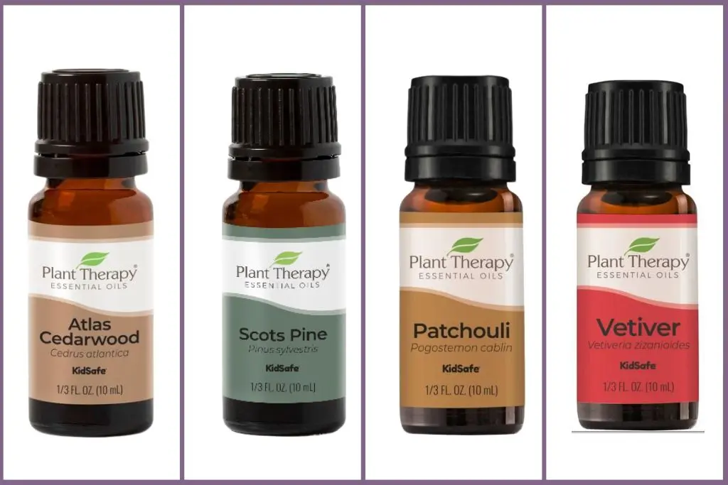 4 earthy essential oil bottles - cedarwood, pine, patchouli, vetiver