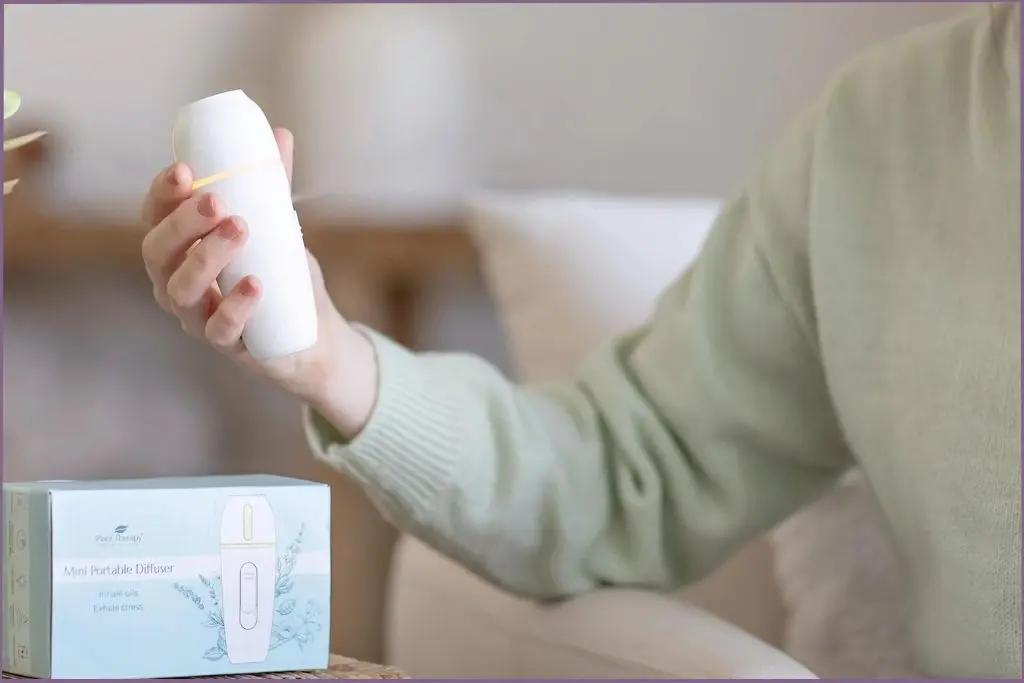 lady holding portable diffuser with deep sleep diffuser blends