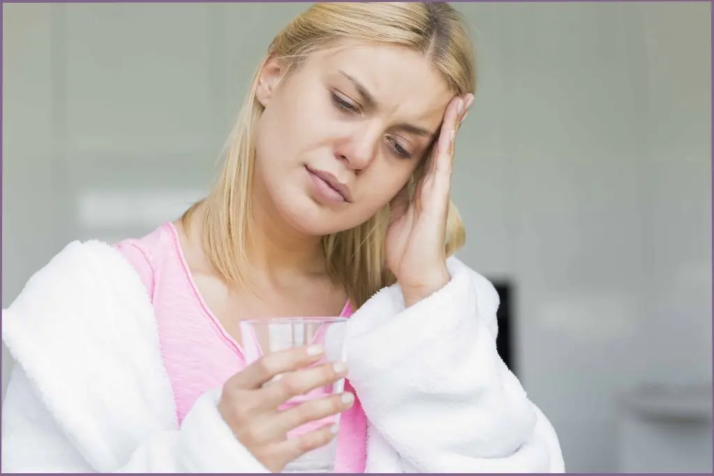 lady with a headache holding her head