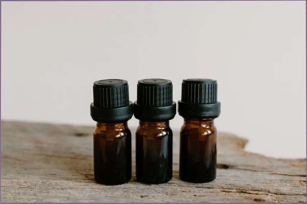 3 small essential oil bottles on a wooden base