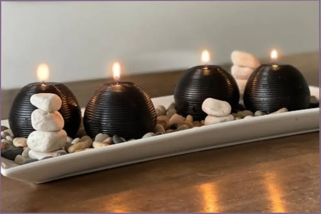 4 black halloween scented candles on white tray on table