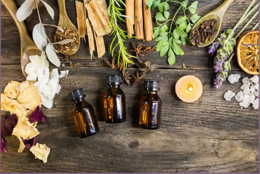 assortment of herbs with 3 essential oil bottles - Ancient & Modern Uses Of Essential Oils