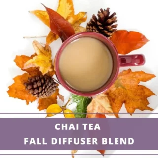 cup of chai surrounded by fall leaves and pine cones