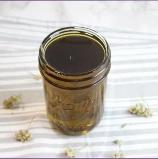 bottle of homemade yarrow infused oil - how to make yarrow infused oil