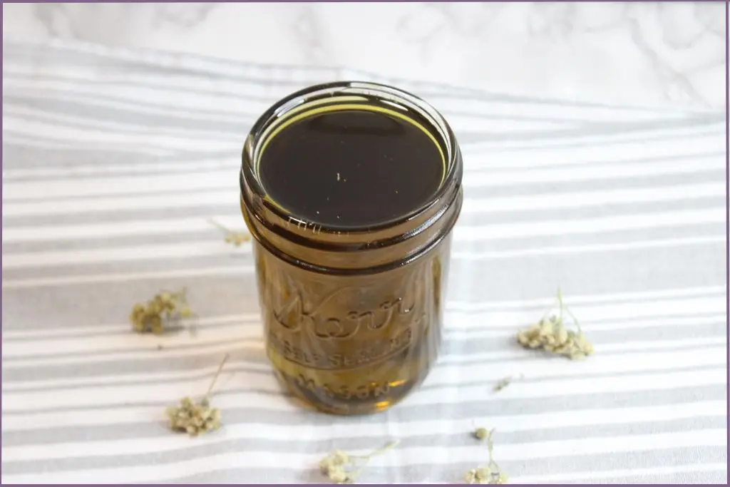 bottle of homemade yarrow infused oil - how to make yarrow infused oil