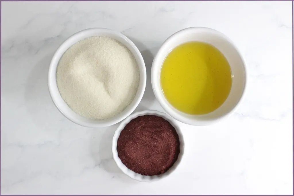 3 bowls with ingredients for sugar scrub - sugar, carrier oil, and hibiscus flower powder