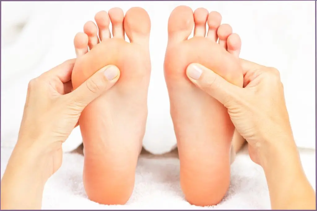 person pressing soles of the feet- pulse points for essential oils