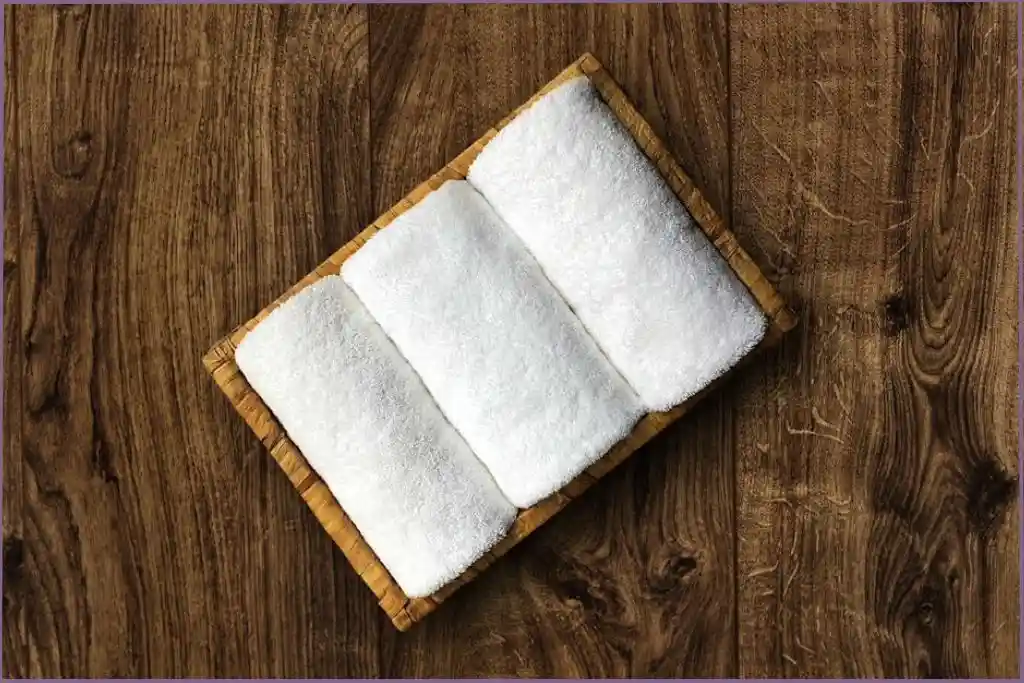 3 small white towels in a tray