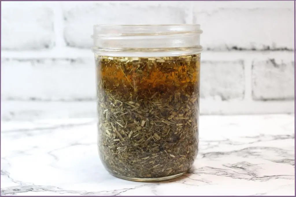 bottle of homemade yarrow infused oil - what is yarrow oil