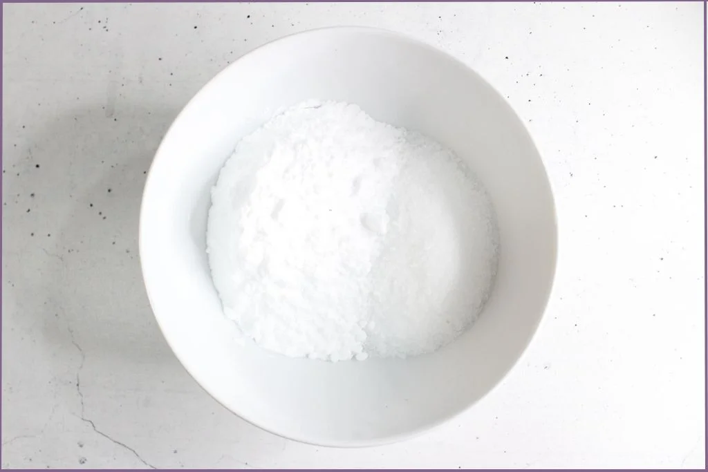 mixture of baking soda and epsom salts in a white bowl for making homemade eucalyptus shower steamers