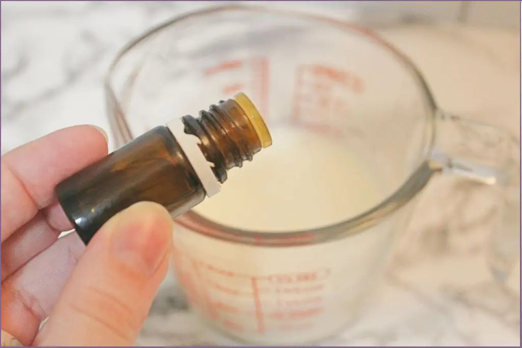 pouring essential oil in whipped body butter