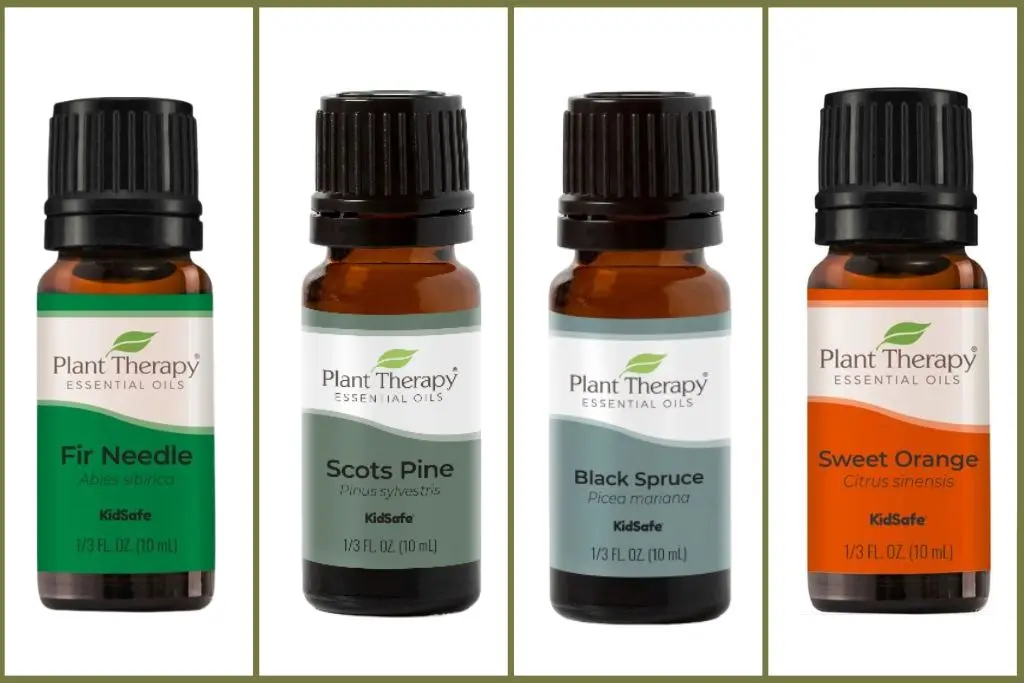 4 esssential oil bottles to make christmas tree blends - fir needle, scots pine, black spruce, sweet orange