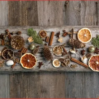 orange slices, potpourri, and spices on a table to make Christmas potpourri