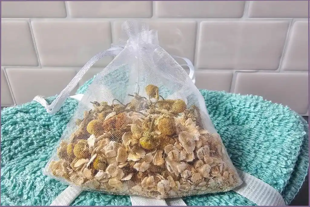 mesh bag filled with chamomile and oatmeal for homemade herbal bath tea bags