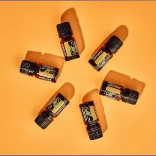 6 bottles of kumquat essential oils arranged in a circle - do essential oils expire
