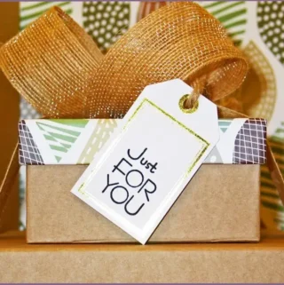 brown box converted into a gift basket with big bow and a label saying 'just for you'