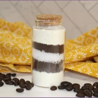 bottle of coffee bath salts with coffee beans on table