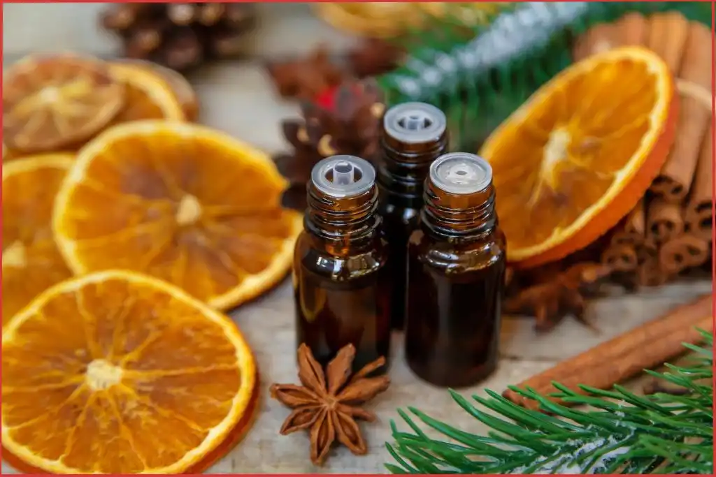 3 essential oil bottles in Christmas setting