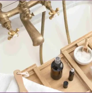 bath tray with essential oil bottles and bath salts