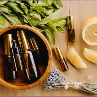 round wooden bowl with bottles of essential oil blends from different aroma families