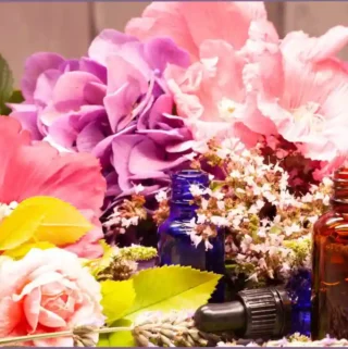 essential oil bottles amidst spring flowers