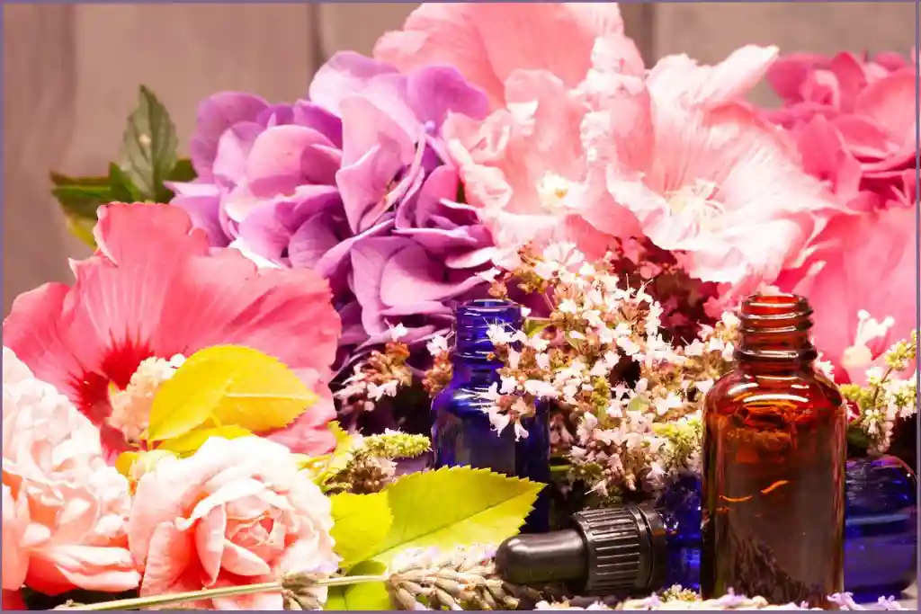 essential oil bottles amidst spring flowers