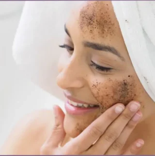 lady using face scrub with essential oils on her face - ways to use essential oils in your skincare routine