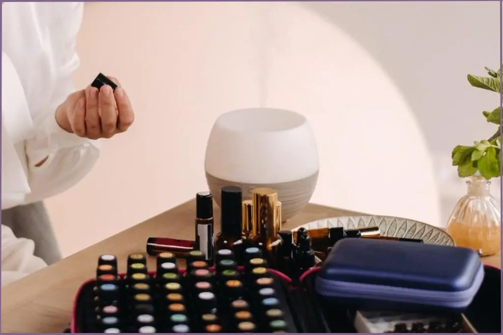 essential oil bottles in a box next to a diffuser