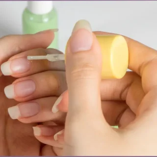 lady applying carrier oil to cuticles - how carrier oils work to nourish cuticles