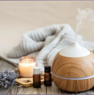 aroma diffuser with essential oils in hygge setting - Benefits of aromatherapy for selfcare practices