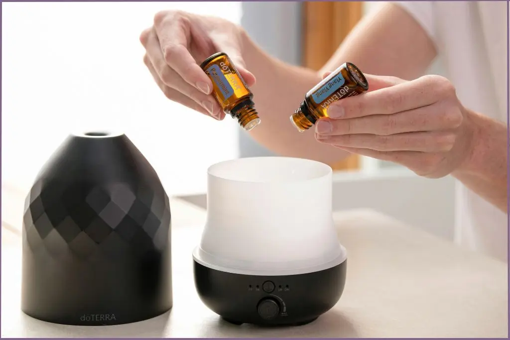 Putting peppermint and ylang ylang essential oil in diffuser