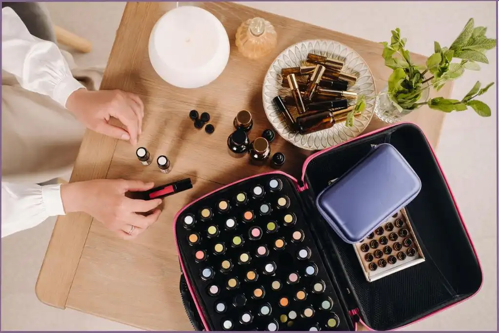 Aromatherapy diffuser, essential oil bottles, and roller bottles on a wooden table