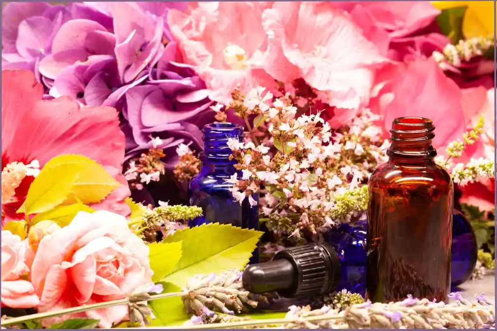 essential oil bottles surrounded by flowers to make Floral boho chic diffuser blends