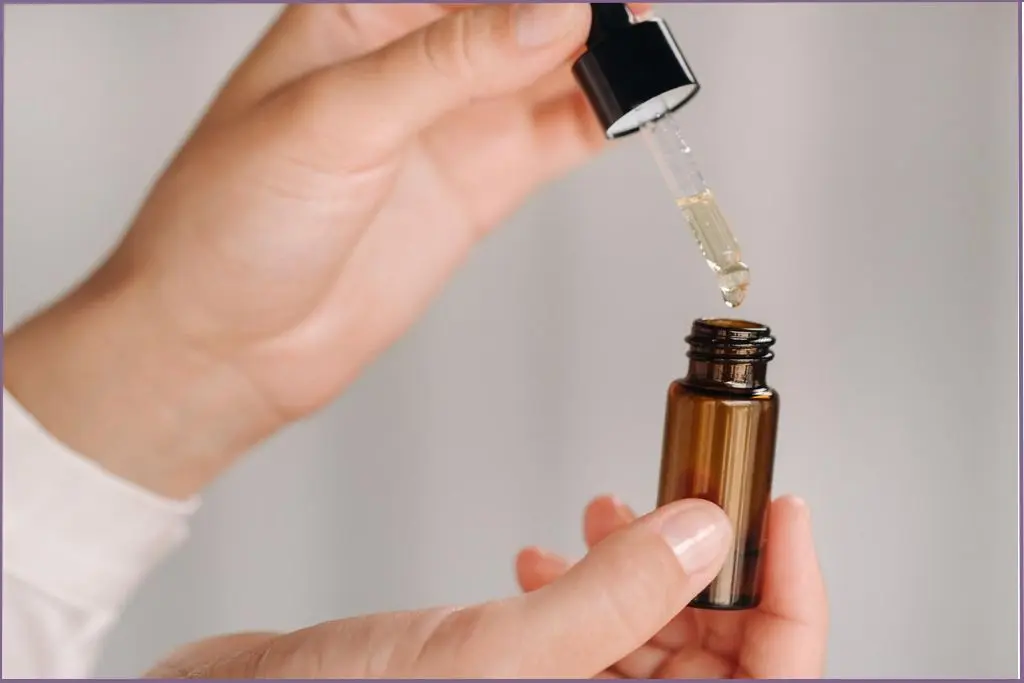 lady using dropper for essential oils - How many drops in 10 ml essential oil