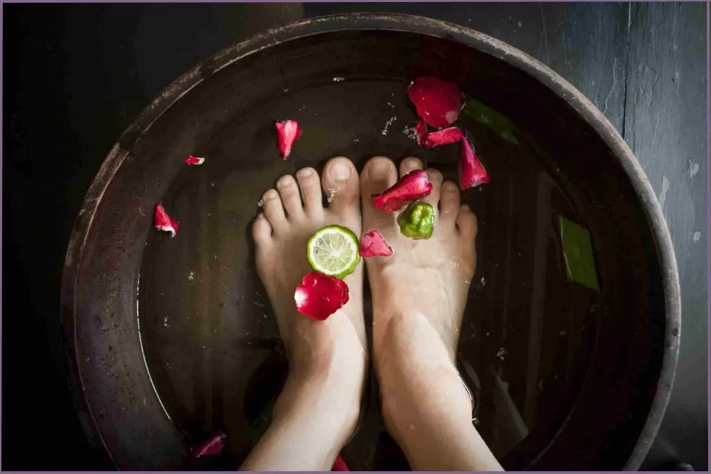 feet soaking in a basin of water preparing to apply a homemade foot scrub