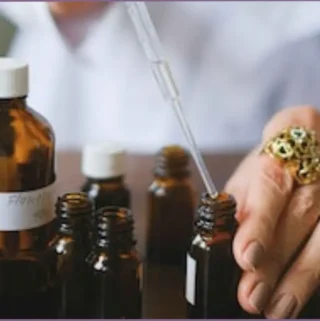 lady using a dropper for blending essential oils