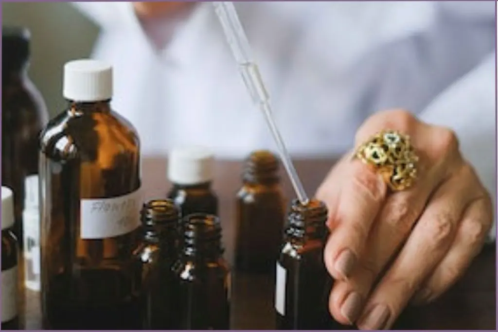 lady using a dropper for blending essential oils