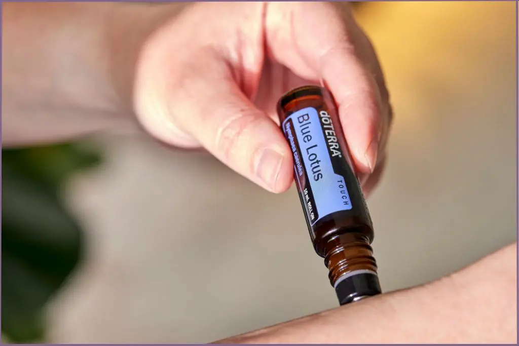 lady applying an essential oil roll-on to forearm