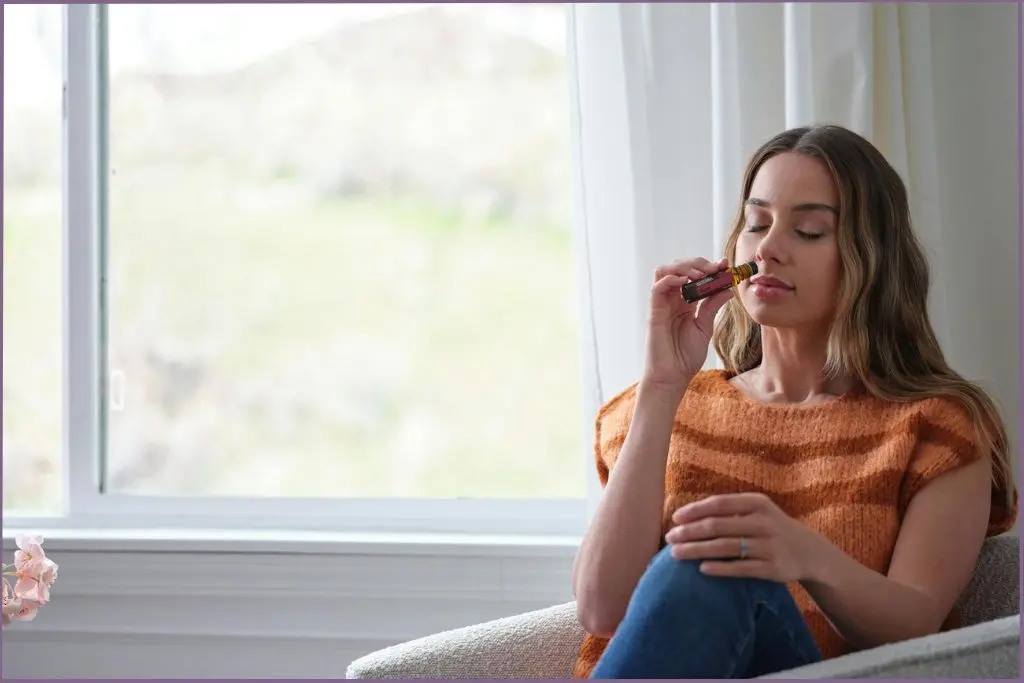lady sniffing essential oil for high altitude comfort directly from the bottle