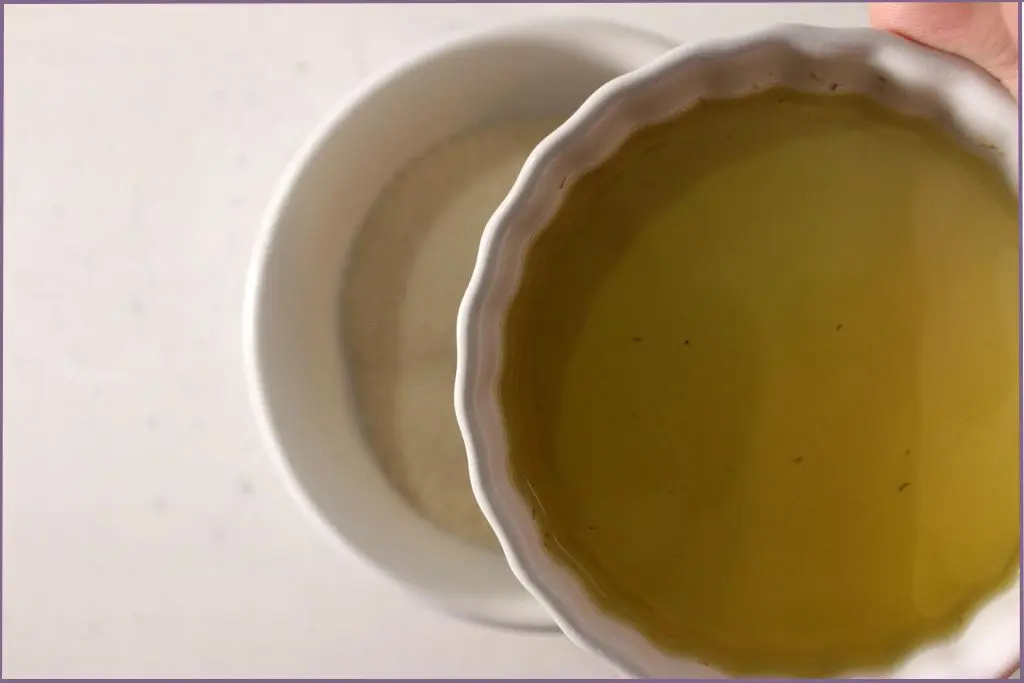 Adding carrier oil to sugar to make pumpkin spice body scrub